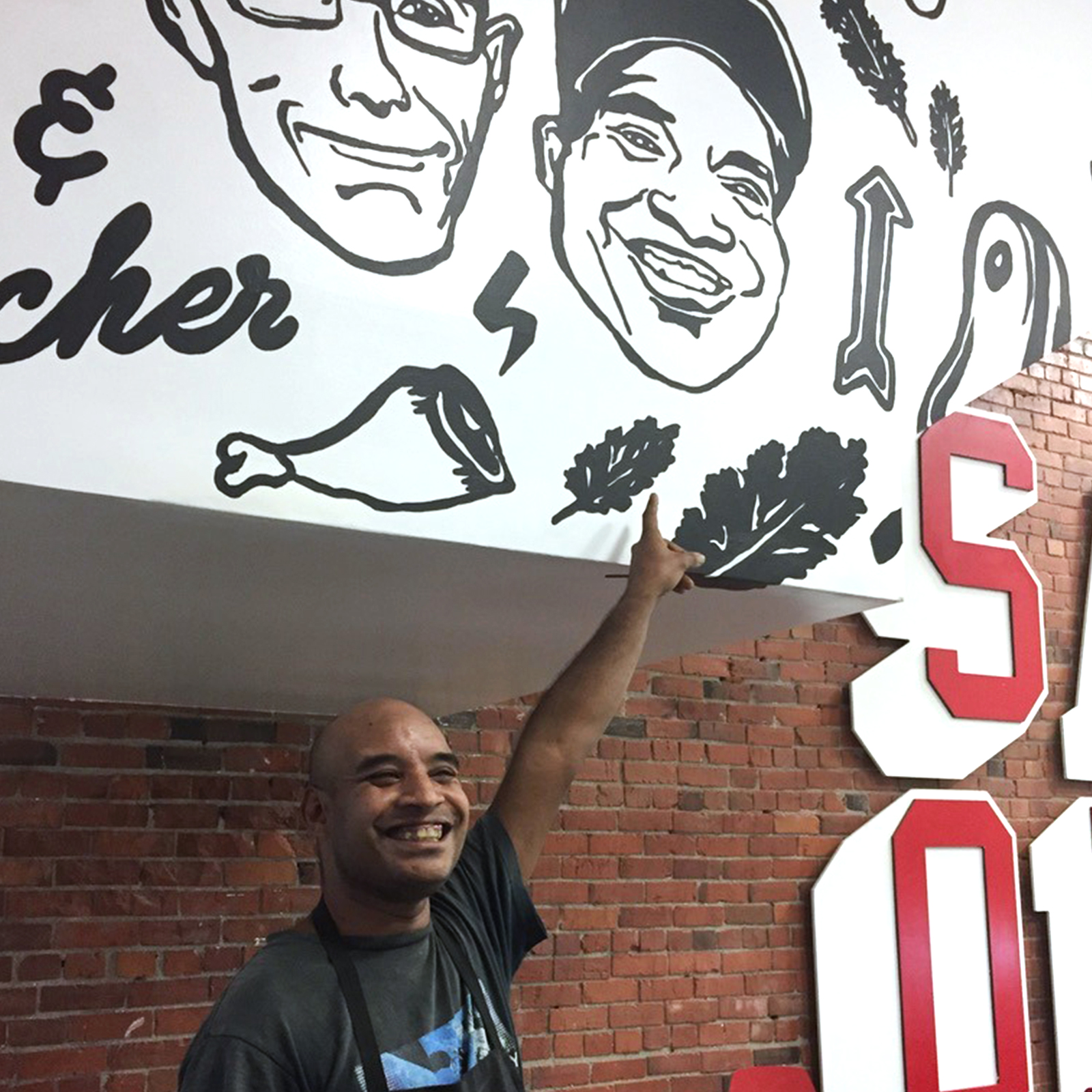 longtime staff member Brad with his portrait in the legendary Save On Meats butcher shop